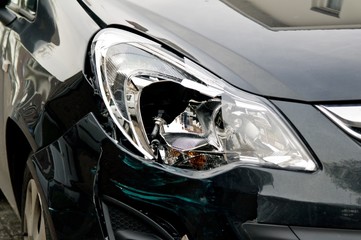 Broken headlamp on a black car