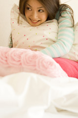 Japanese woman in her twenties holding cushion