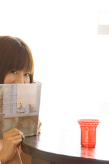 Japanese woman in her twenties hiding month with book