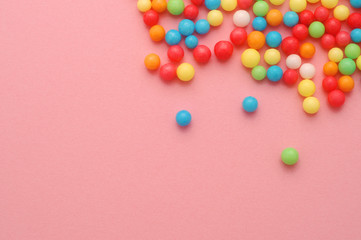 Cute little sweeets on pink background with copy space