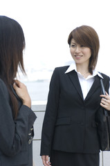 Two Japanese women in their twenties talking outside