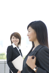 Two Japanese women in their twenties looking outside