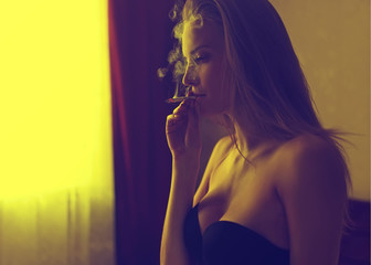 Portrait of beautiful girl in profile, with a cigarette