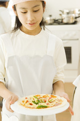 Japanese girl preparing for cooking in kitchen