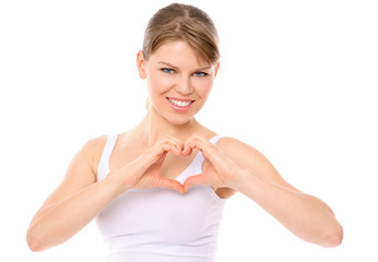 Pretty smiling girl showing heart shape, isolated on white