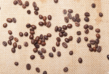 Coffee beans on burlap background