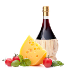 Red wine bottle, cheese and tomato still life