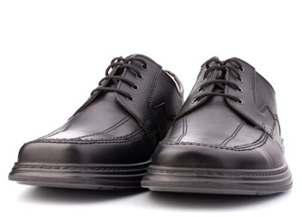 Black glossy man’s shoes with shoelaces