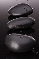 Spa stone arrangement on black surface. Healthcare concept.