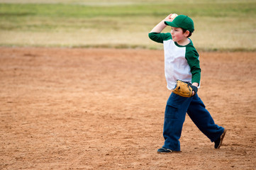 Boy throws baseball during practice