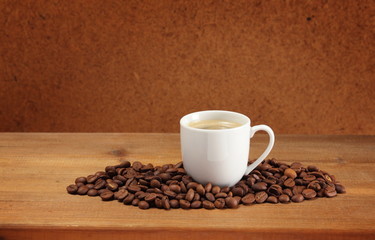 Coffee beans and cup on a wooden table