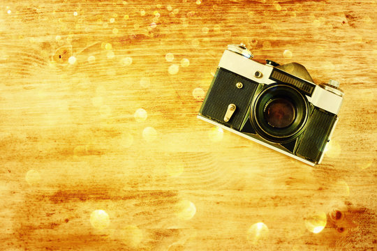 vintage old camera on brown wooden background