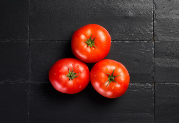 Fresh and Health Tomatoes over Black Slate