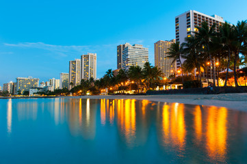 Beach at Waikiki with buildings and reflections