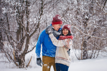 Fototapeta na wymiar Guy and girl walk and have fun in the forest