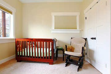 Nursery with simple setting and beige walls.
