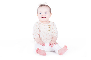 Sweet baby girl sitting and laughing