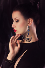 Portrait of beautiful young woman with makeup with jewelry