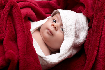 Beautiful baby in towel after bathing