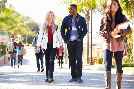 Students Walking Outdoors On University Campus