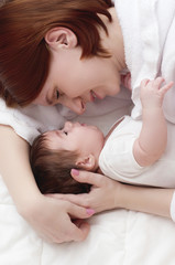 Obraz na płótnie Canvas Young happy mother with baby
