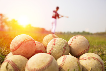 Baseball players practice wave a bat in a field