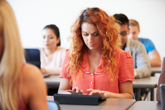 Female University Student Using Digital Tablet In Classroom