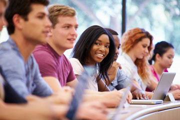 Class Of University Students Using Laptops In Lecture