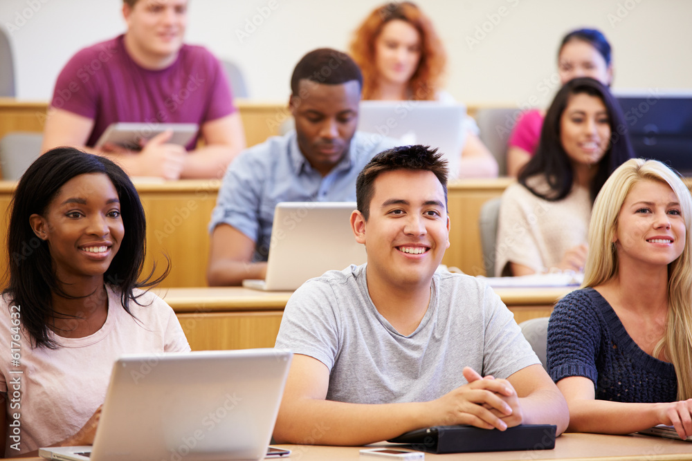 Wall mural students using laptops and digital tablets in lecture