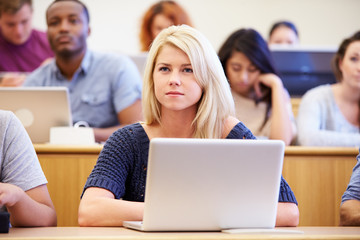 Female University Student Using Laptop In Lecture