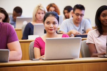 Female University Student Using Laptop In Lecture