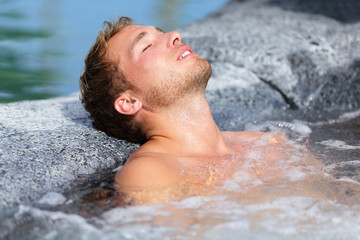 Wellness Spa - man relaxing in hot tub whirlpool