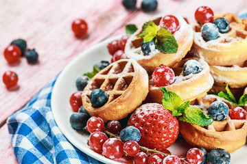 Waffles with fresh berries on the table