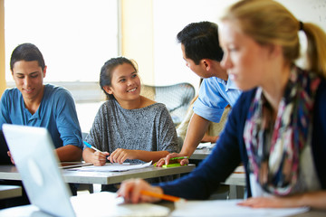 High School Students With Teacher In Class Using Laptops