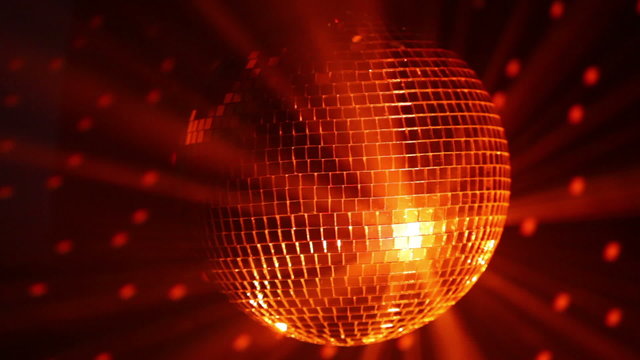 Orange disco ball and reflected dots on the wall, loop-ready