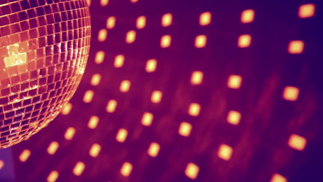 Part of purple disco ball effect and reflected dots on the wall