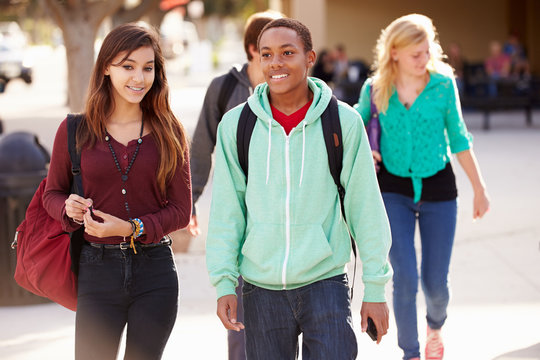 Male And Female Students Walking To High School