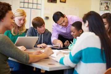 High School Students With Teacher In Class Using Laptops - obrazy, fototapety, plakaty