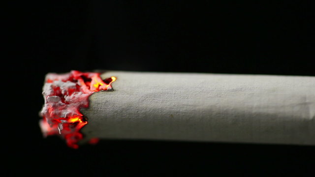 Closeup view of burning cigarette in time-lapse, HD 1080