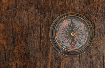 old compass on wood background