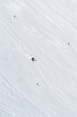 Skiers going down the slope at ski resort