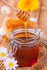 Still life of honey on wooden table