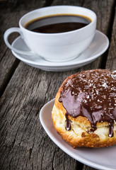 breakfast with donuts and coffee on wood table