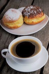 breakfast with donuts and coffee on wood table