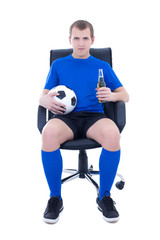 young attractive man in football form sitting with ball and bott