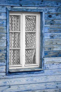 Rural much neglected window in wooden wall, wooden background