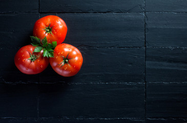 Fresh and Health Tomatoes over Black Slate