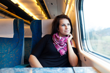 Young woman travelling by train - 61780200