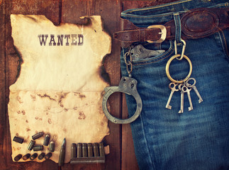 background in the style of the American West. Handcuffs in jeans
