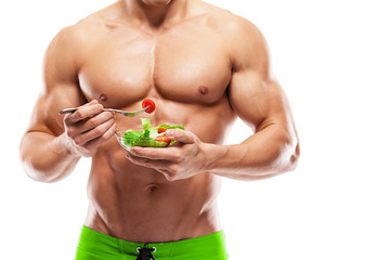 Shaped and healthy body man holding a fresh salad bowl,shaped ab